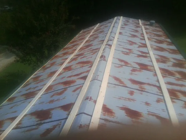 Rusted metal roof panels with new wood purlins before replacement — Storm Damage Roof Repair in Oostburg by Roofing Brothers